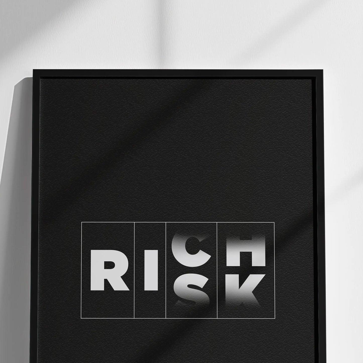 Closeup of Framed poster with 'RICH RISK' text on a white wall, Money Motivational Wall Art for Risk Takers | For Home, Office rooms