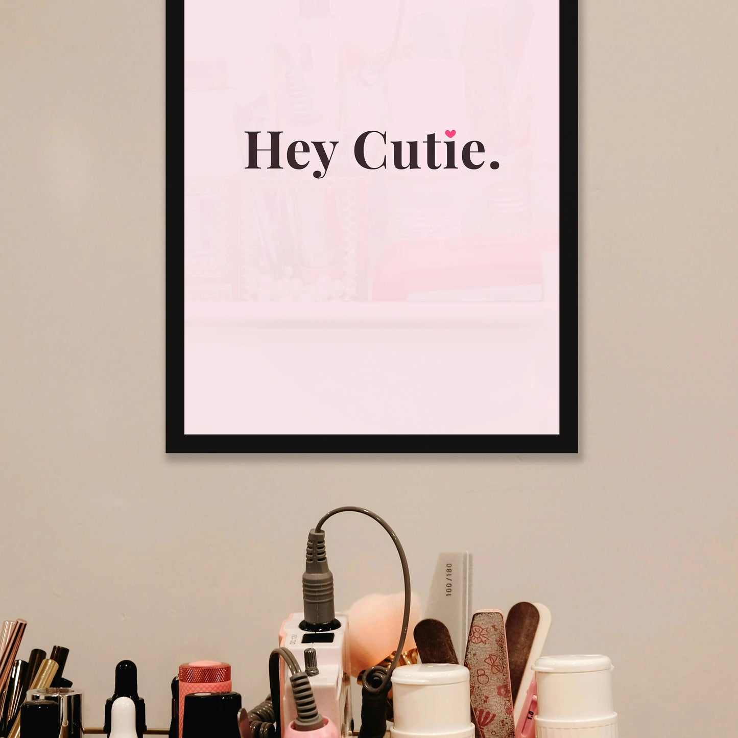 Framed artwork with 'Hey Cutie' text on a wall above a vanity setup. for salons and parlours, cute photo frame for girls