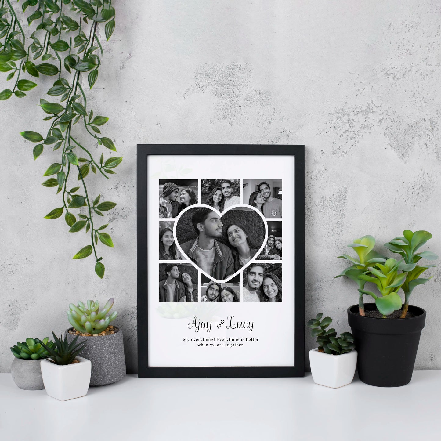 Valentine's & Anniversary Gift idea, black & white Framed photo collage of a couple with a heart design, placed on a white surface with plants around. Ajay & Lucy