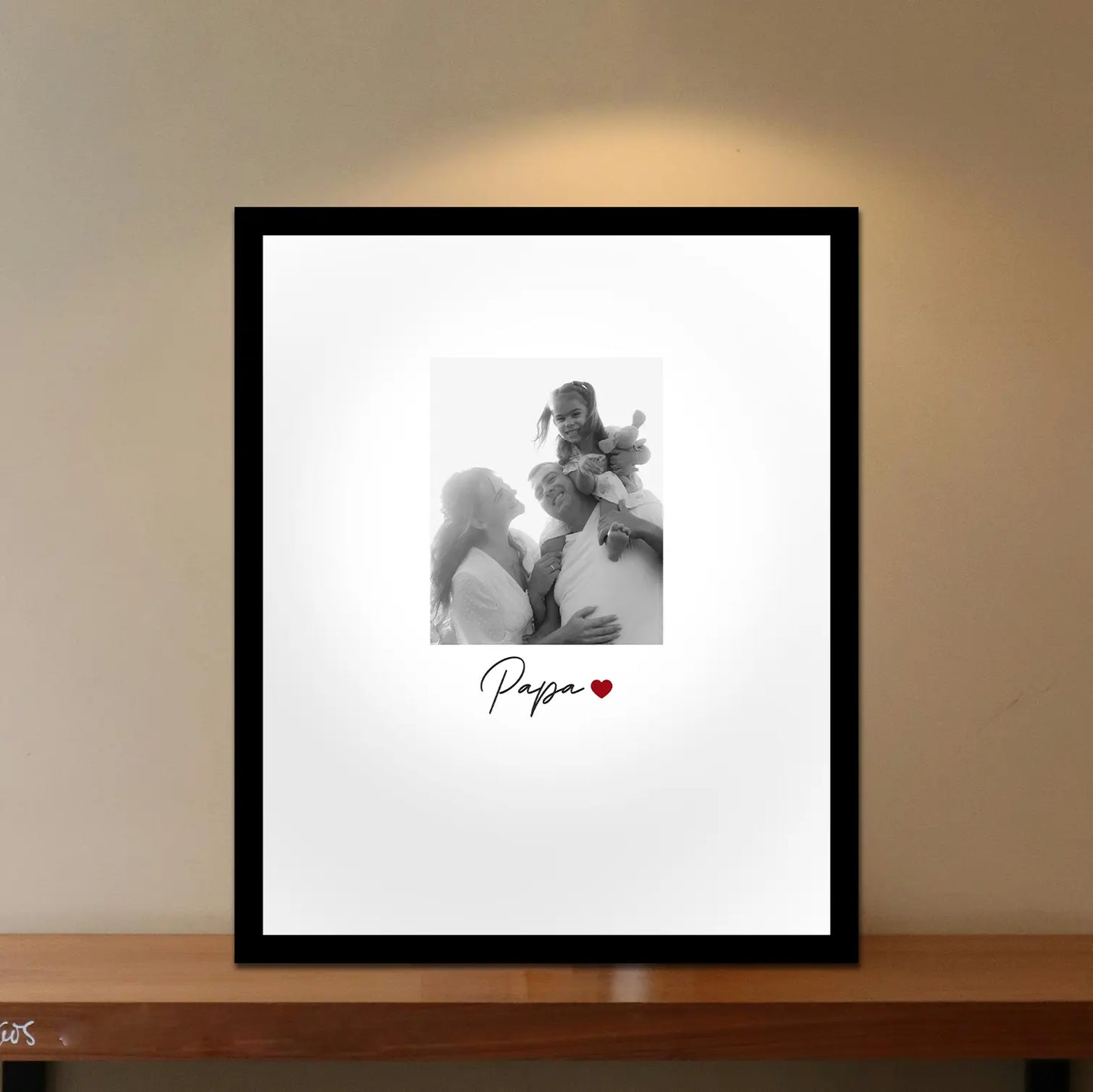 Framed photo of a family on a wall with 'Papa' and a heart symbol. Framiqa custom photo frame gift for Father's day